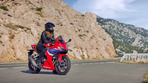Vista dianteira a três quartos da CBR500R com condutora